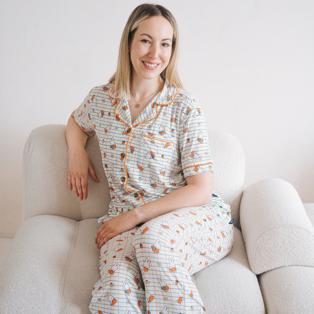 Vrouw die de Ladies nijntje Checkered Bloom-pyjamaset van bamboe draagt